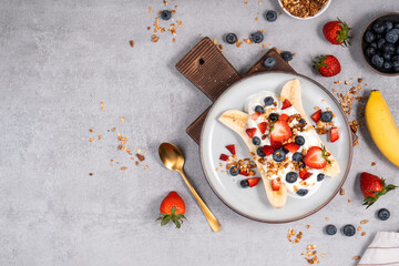 Healthy Banana Split Breakfast with Yogurt, Granola and Fresh Berries