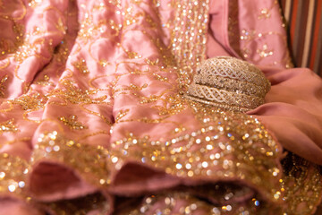 stone studded bangles spread on a  delicate intricately designed satin lehenga