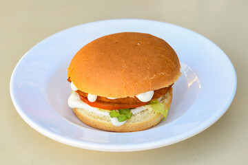 Big tasty burger with beef cutlet on a plate. Hamburger, cheeseburger with mushroom. Crispy chicken burger.