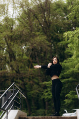 fitness, sport and healthy lifestyle concept - happy smiling young african american woman with earphones running upstairs outdoors