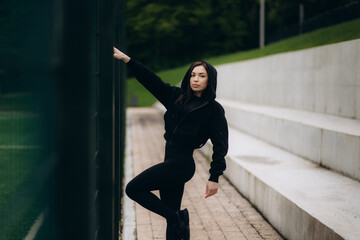 Young sportswoman resting after running.