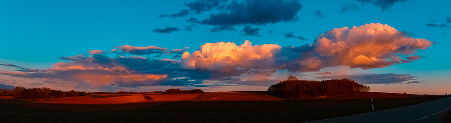 High resolution stitched spring sunset panorama with dramatic clouds near Ettling, Isar,...