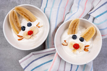 Obraz na płótnie Canvas Kids Breakfast Idea, Rabbit Yogurt Bowl with Banana and Fresh Berries