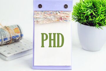 Doctorate of Philosophy concept. PhD It is written on a piece of desktop calendar on a white background