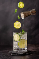 Drink photography of cocktail; lime; mint, cucumber, gin, tonic, shot, jigger, mocktail; mojito;...