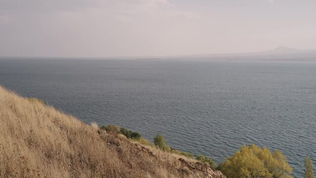 Slow motion of Sevan lake in October on a hazy day