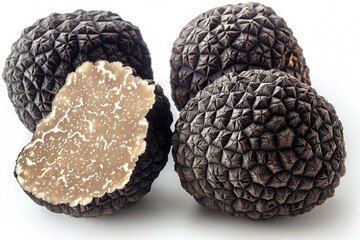 Raw black truffles with textured caps on white background closeup. Delicatessen condiment food products in studio. Mushrooms for special recipes.
