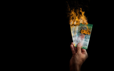 Swiss Franc burning flame held by hand