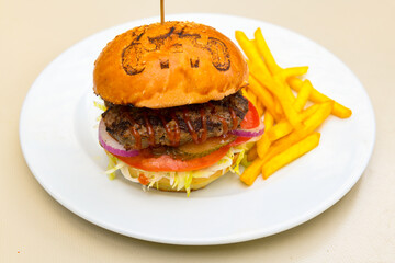 Big tasty burger with beef cutlet on a plate. Hamburger, cheeseburger with mushroom. Crispy chicken burger.