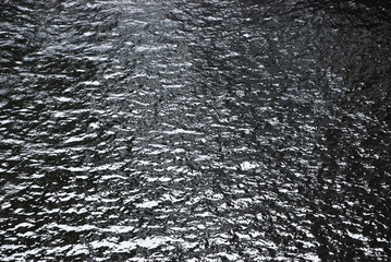 black water surface of a deep dark lake in scotland, united kingdom