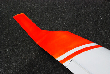 tip of the wing of a gliding airplane, marked with bright orange neon color