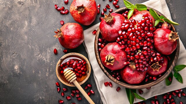   A table is adorned with a bowl of pomegranates A spoon rests nearby, and a cloth bearing pomegranate prints completes the setup