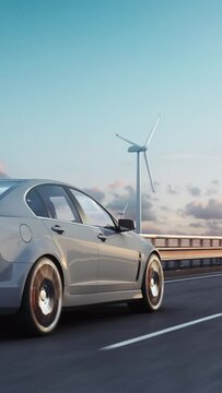 3D render of generic electric car drives on a highway with wind turbines in the background at sunset. Realistic 3d animation. Vertical shot