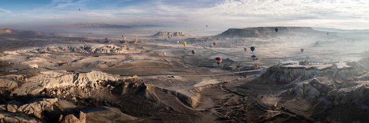 Panoramic view of hot air ballons over Cappadocia at sunrise
