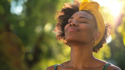 Close up portrait of beautiful young black woman smiling outdoors with a yellow bandana