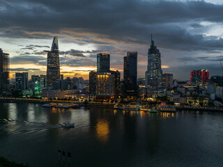 Fototapeta na wymiar Aerial drone skyline video of Saigon cityscape at sunset in District 1, with Sai Gon river view