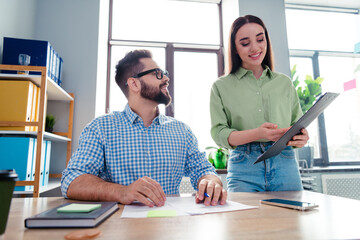 Obraz premium Photo of positive happy coworkers wear shirts showing new working contracts indoors workplace workstation