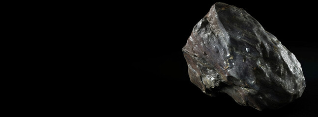 Fototapeta premium Cerite fossil mineral stone. Geological crystalline fossil. Dark background close-up.