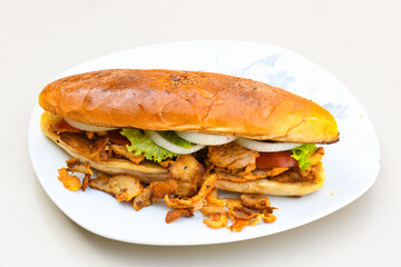 Turkish and Arabic Traditional Ramadan doner kebab with tasty tomato sauce and rice or turkish pilav in white plate on wood table background. ( Pilav ustu doner). Ekmek arasi doner, doner durum. 