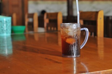 iced tea on wood table with bokeh background