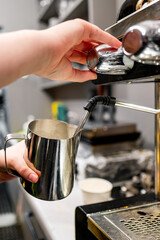 Barista skillfully steaming milk for a fresh cup of coffee, capturing the intricate details of coffee preparation