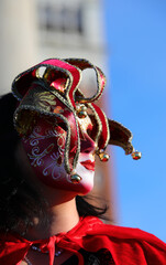 Venice, VE, Italy - February 13, 2024: Venetian Mask at the Carnival with with red lipstick