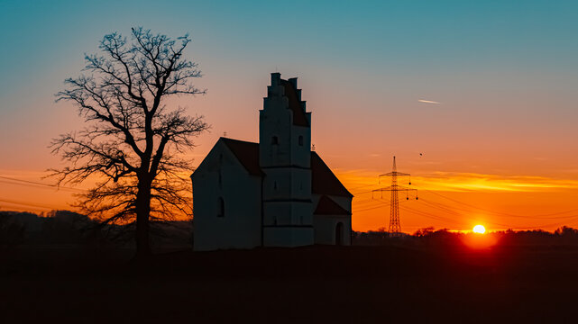 Sunset with a church silhouette at Huett, Eichendorf, Dingolfing-Landau, Bavaria, Germany