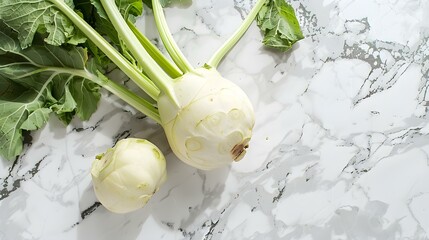 Kohlrabi lie on the surface of white marble