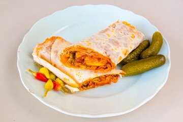 Lavash doner kebab ( zurna et tavuk doner durum )  or shawarma sliced in plate isolated. 