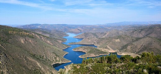 Medal Snake Viewpoint sunny landscape formed with trees, hills, lake Bragança Portugal 