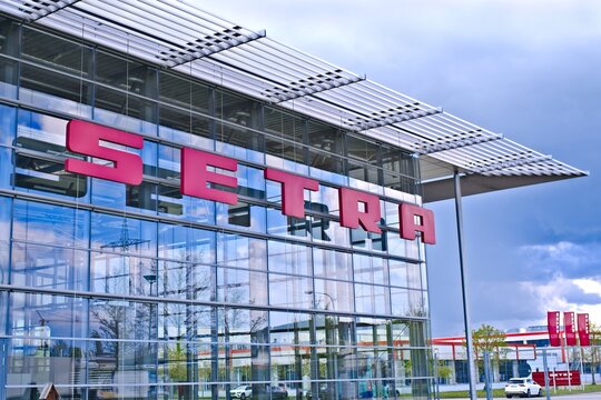 Neu-Ulm, Germany - April, 19, 2024:  Facade of SETRA automotive company Daimler Truck Holding AG on dramitic sky.
