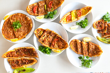 Delicious meat kebab with fresh vegetable salad served with variety of Turkish dishes and appetizers. Top view of assorted Turkish food and meze, tasty and healthy Mediterranean cuisine.