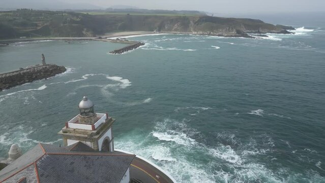 Aerial drone shot of Luarca lighthouse with Cantabrian sea
