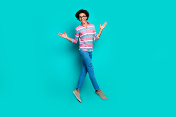 Photo of nice handsome man wear trendy striped clothes walk fly air isolated on cyan color...