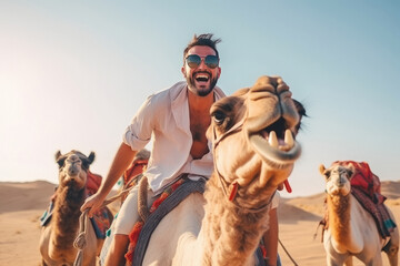 young man having fun and enjoying with camel ride