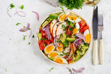 Healthy cobb salad with chicken, avocado, tomato, red onions and eggs. American food. Top view, overhead