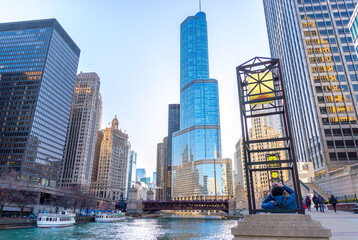 Trump Tower and Chicago River on a clear summer day.
