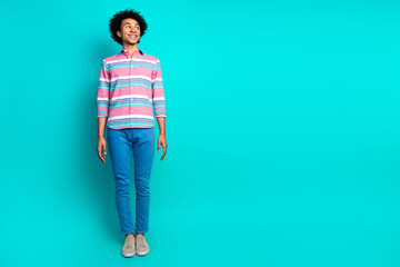 Photo of cheerful nice man wear trendy striped outfit look empty space isolated on cyan color...