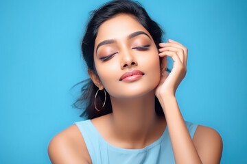 young beautiful indian woman on blue background