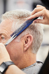 Hands, scissors and comb with man in salon for haircut by hairdresser, barber and hair care...