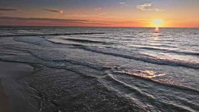 Sun and waves on horizon at Baltic Sea at sunset