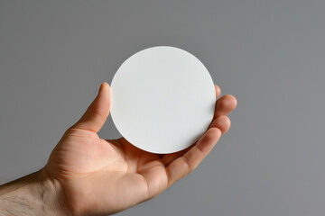 Fototapeta na wymiar White round mockup in hand, for any of your projects.
