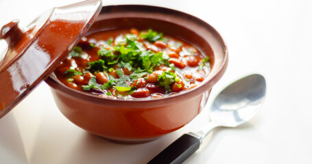 A hearty serving of baked beans in a ceramic dish, a healthy and nutritious meal