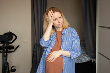 pregnant woman suffers from headache, migraine during pregnancy,