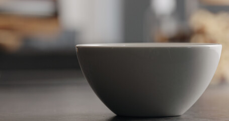 white bowl with granola on terrazzo countertop
