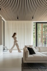 Lumination interior design photography of an apartment with white walls and wooden beams on the ceiling. The living room has natural wood accents. woman is walking through the space towards the camera