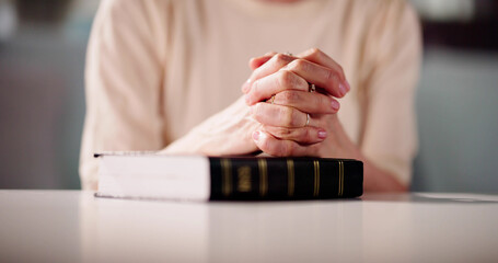 Woman's Hand Over Holy Bible Book