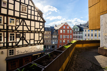 Old half-timbered houses in a city. Streets and buildings in the morning in Wetzlar, Hesse Germany - obrazy, fototapety, plakaty