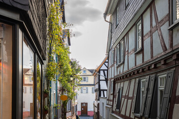 Old half-timbered houses in a city. Streets and buildings in the morning in Wetzlar, Hesse Germany - obrazy, fototapety, plakaty