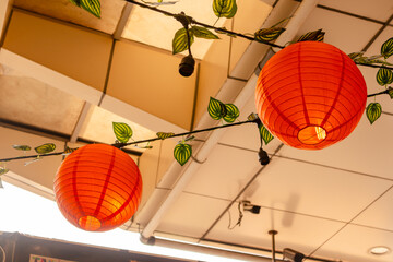 Orange lanterns hanging from the ceiling